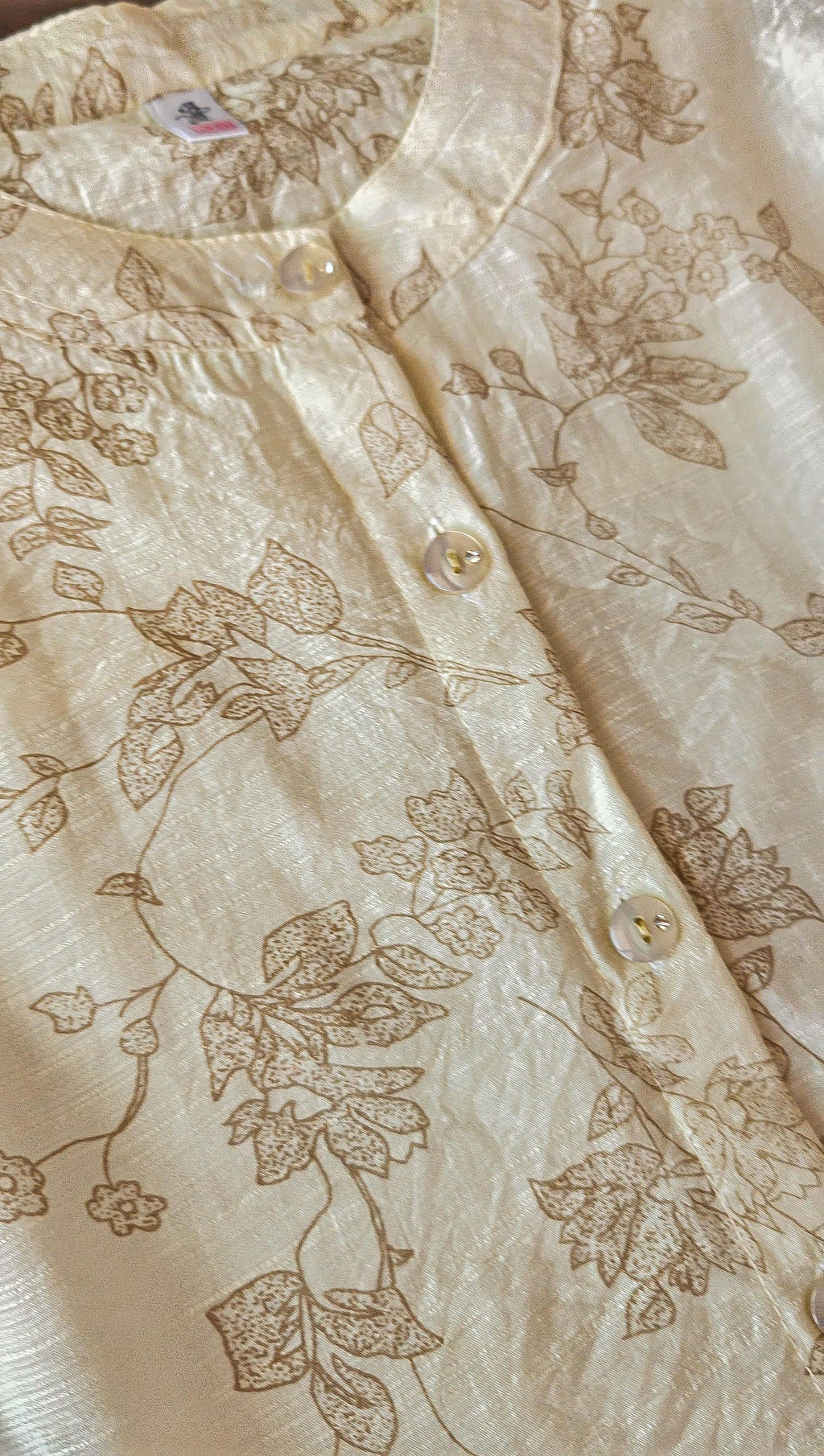 Beige top with floral embroidery pattern