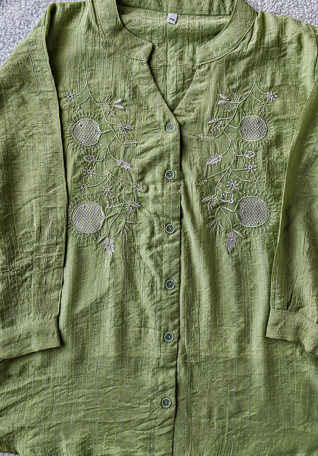 Close up of green embroidered mandarin collar women's blouse