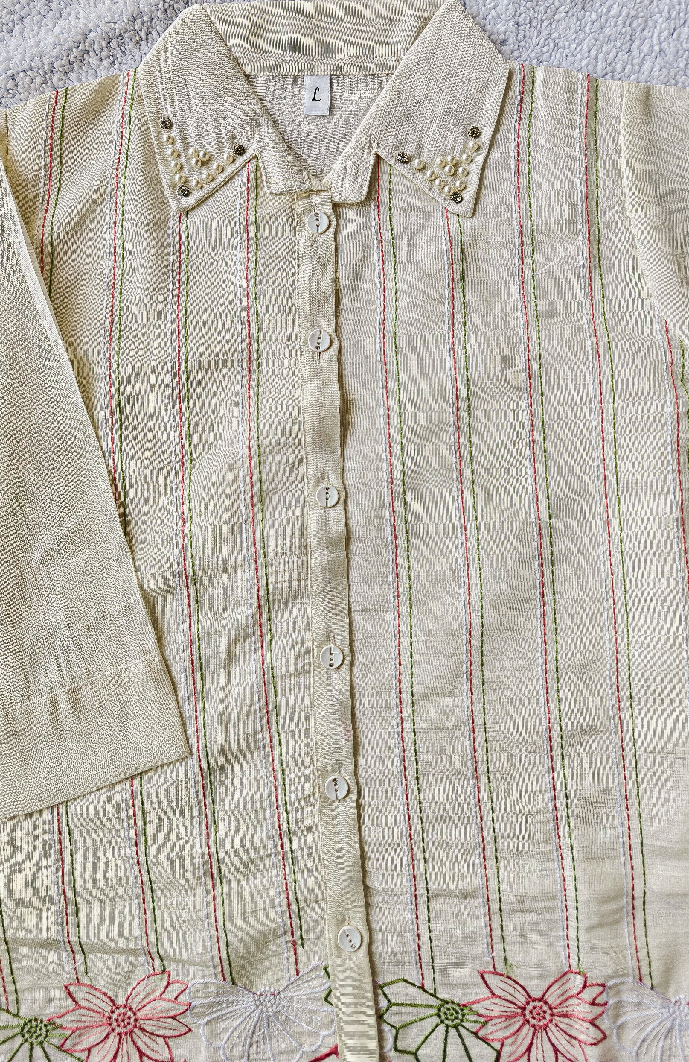 close up of white striped shirt with pink white green floral patterns