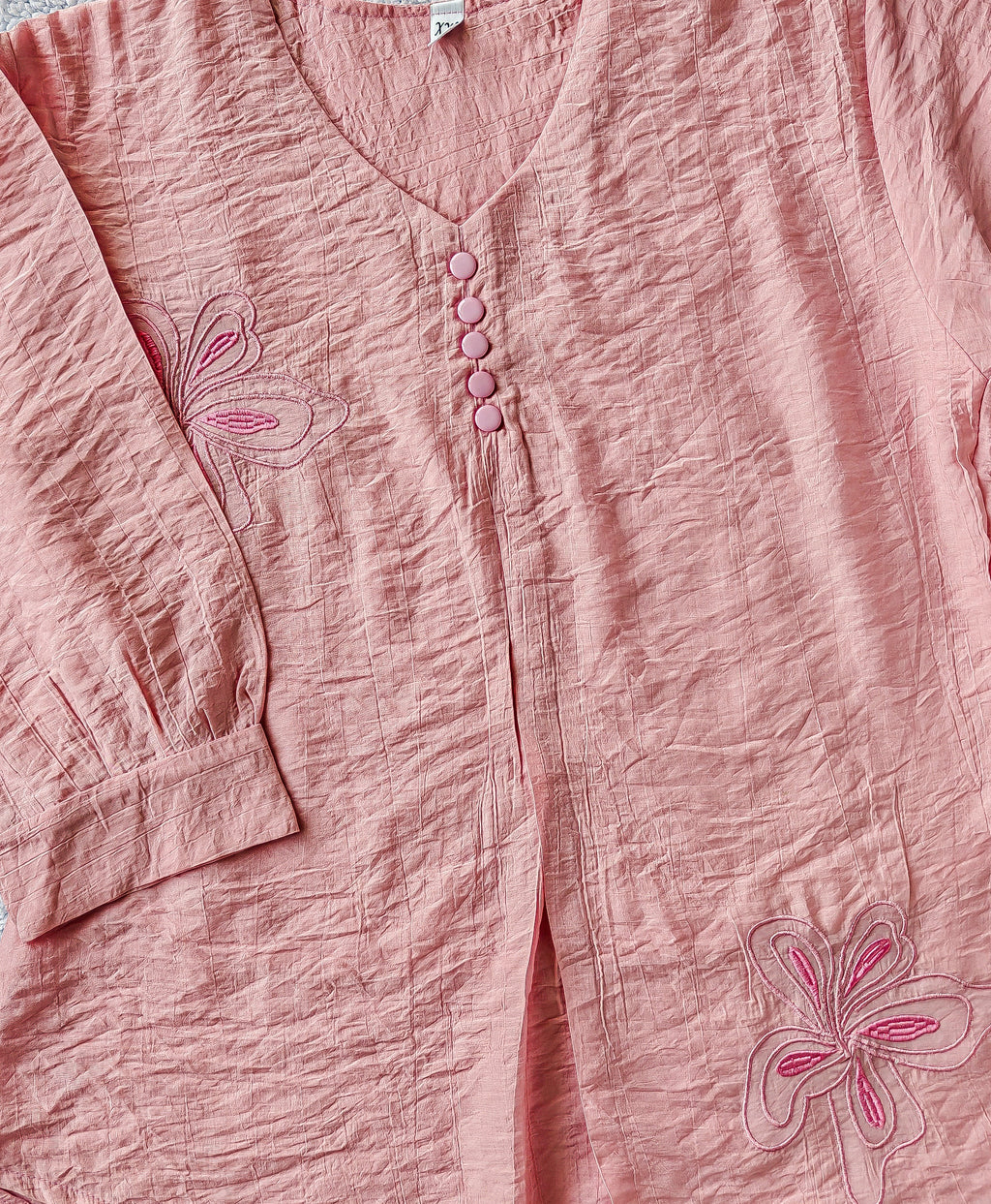 close up pink blouse with floral embroidery