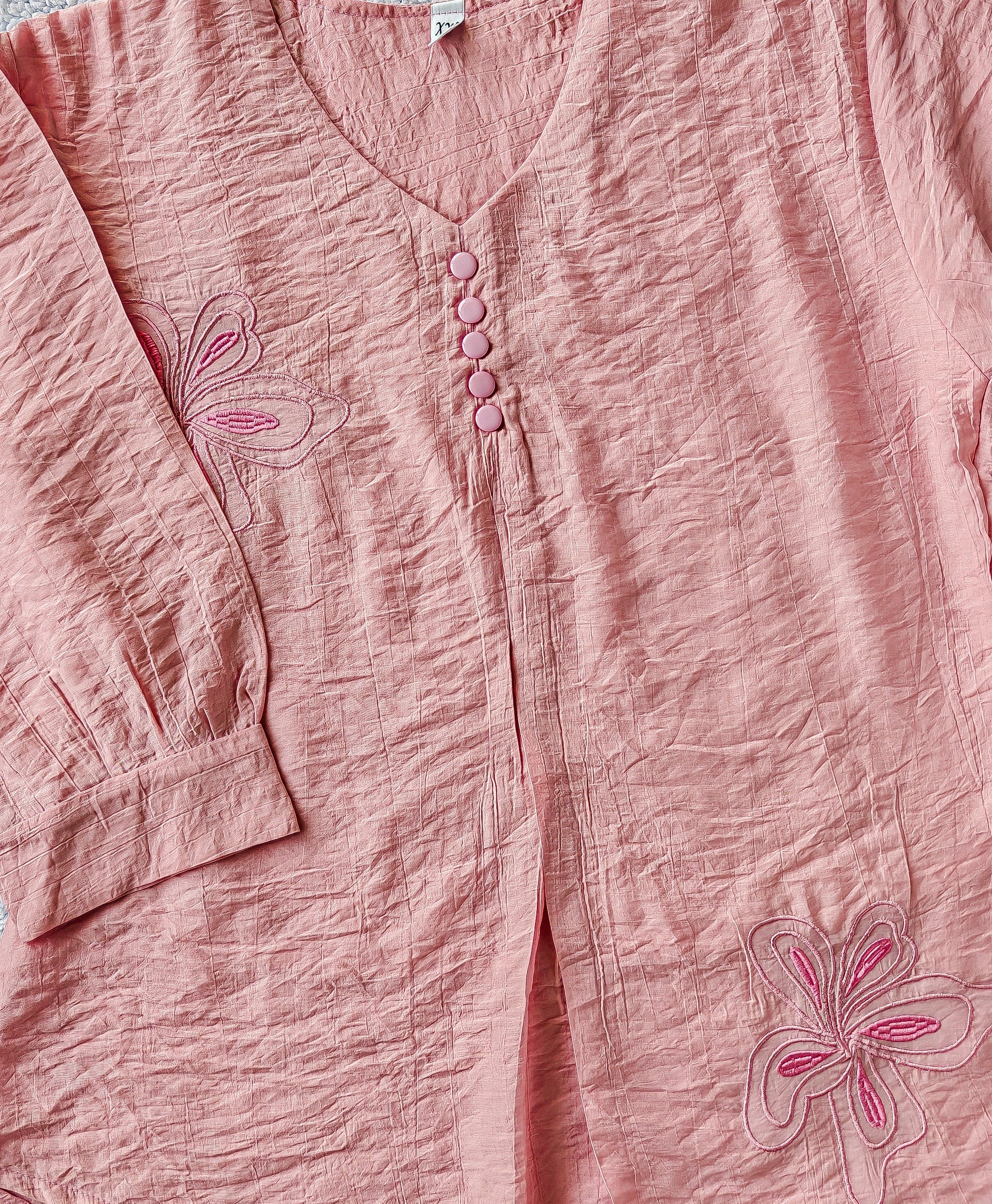 close up pink blouse with floral embroidery