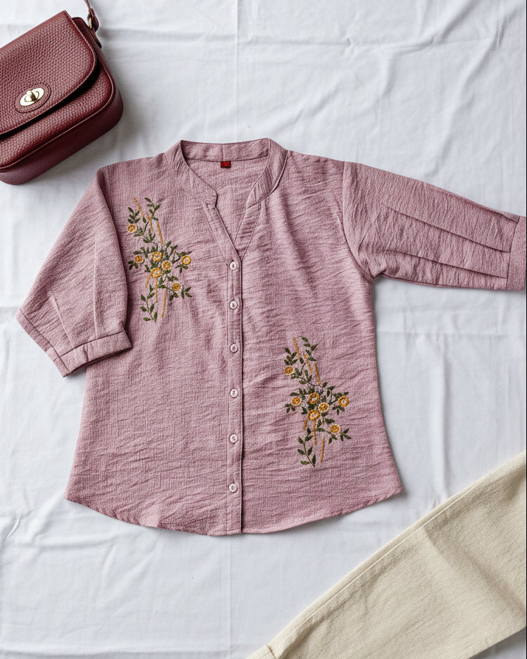 pink women's shirt with floral embroidery