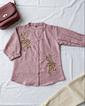 pink women's shirt with floral embroidery
