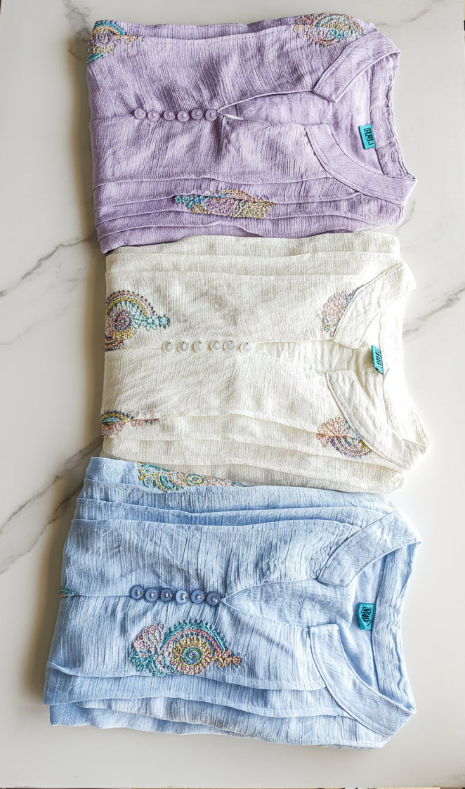 Three pieces of women's clothing tops with colorful embroidered patterns and front pleats