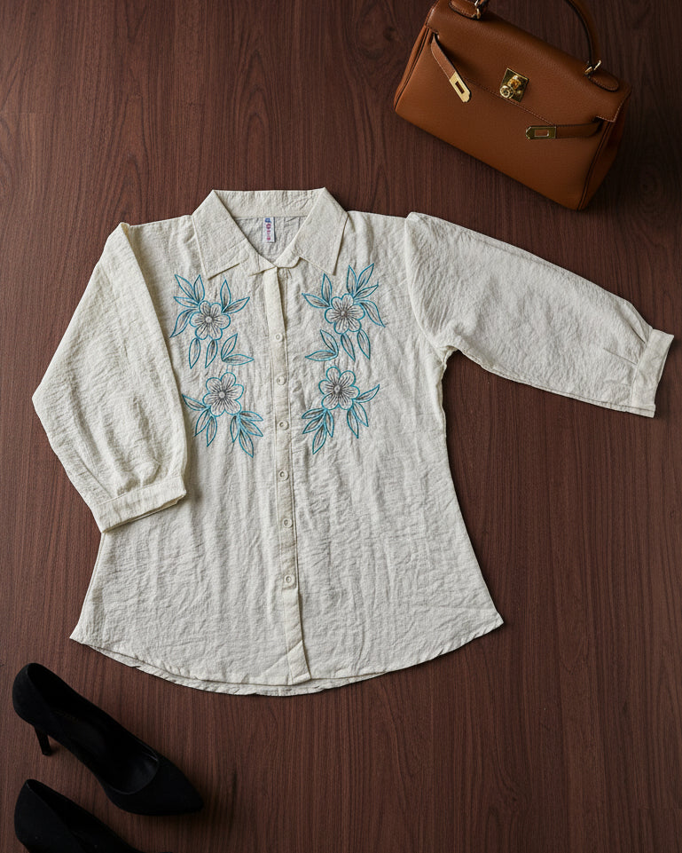 White blouse with blue floral embroidery 